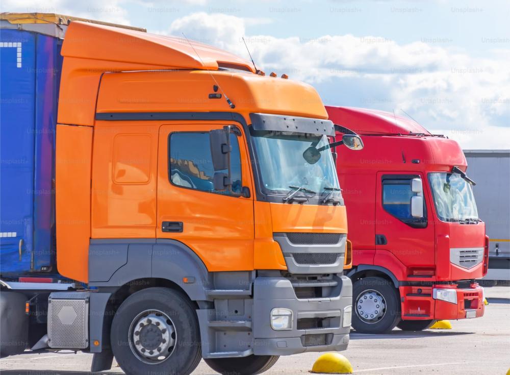 Orange and red trucks parked together